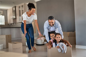 Parents and children playing with moving boxes